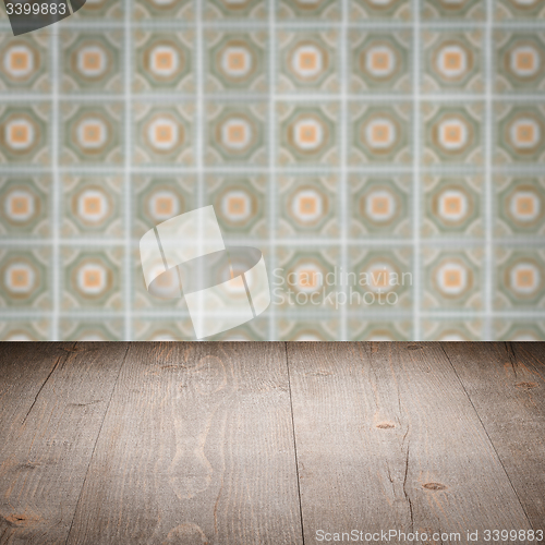 Image of Wood table top and blur vintage ceramic tile pattern wall