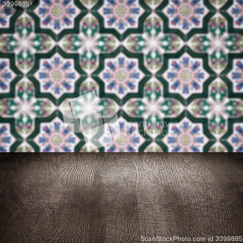 Image of Wood table top and blur vintage ceramic tile pattern wall