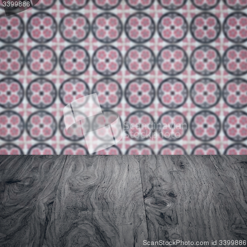 Image of Wood table top and blur vintage ceramic tile pattern wall