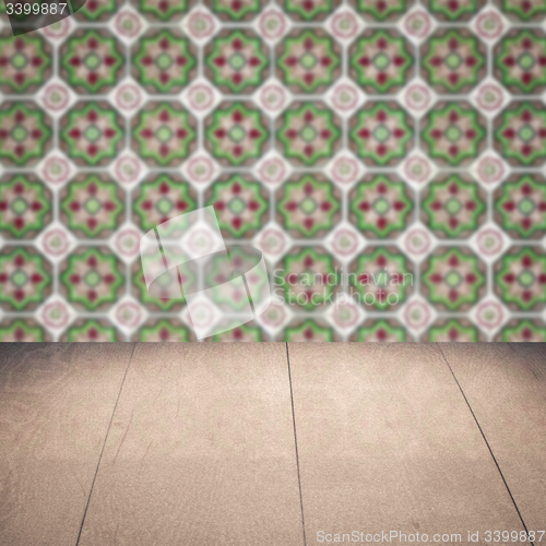 Image of Wood table top and blur vintage ceramic tile pattern wall