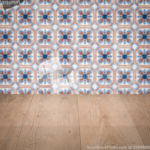 Image of Wood table top and blur vintage ceramic tile pattern wall