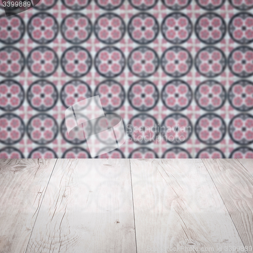 Image of Wood table top and blur vintage ceramic tile pattern wall