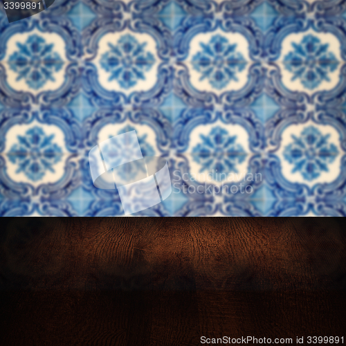 Image of Wood table top and blur vintage ceramic tile pattern wall