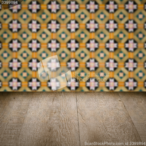 Image of Wood table top and blur vintage ceramic tile pattern wall