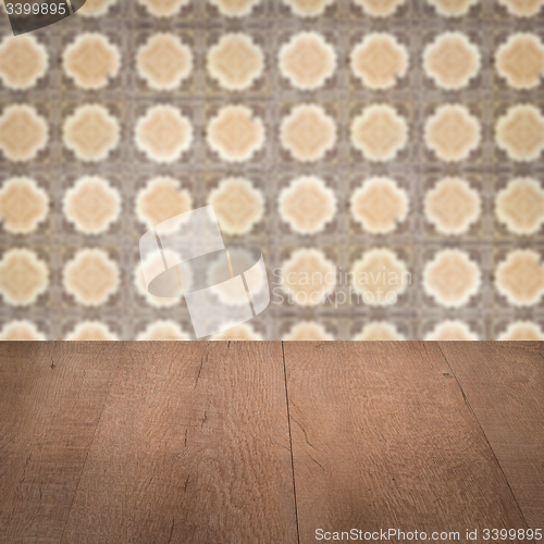 Image of Wood table top and blur vintage ceramic tile pattern wall