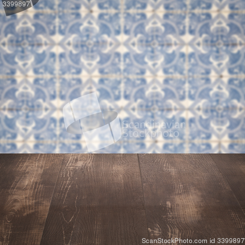 Image of Wood table top and blur vintage ceramic tile pattern wall