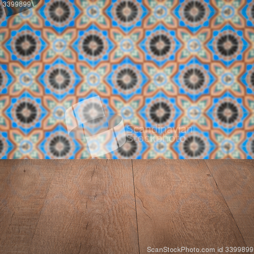 Image of Wood table top and blur vintage ceramic tile pattern wall