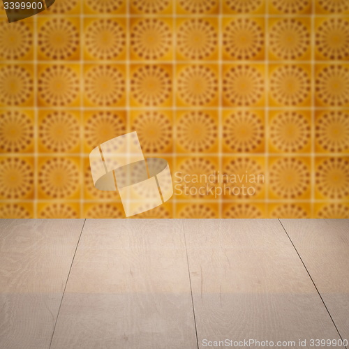 Image of Wood table top and blur vintage ceramic tile pattern wall