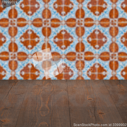 Image of Wood table top and blur vintage ceramic tile pattern wall