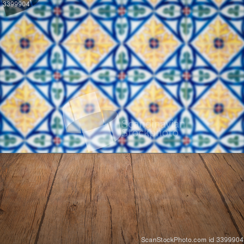 Image of Wood table top and blur vintage ceramic tile pattern wall