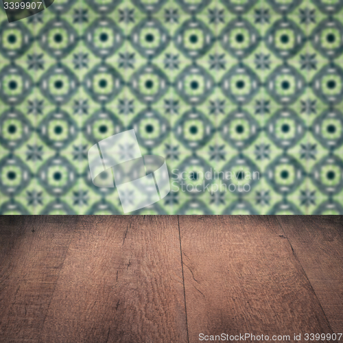 Image of Wood table top and blur vintage ceramic tile pattern wall