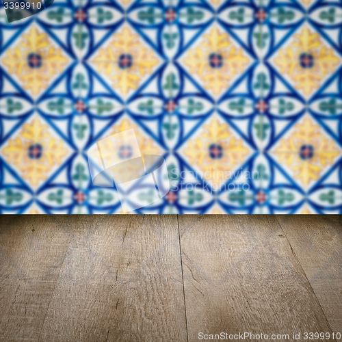 Image of Wood table top and blur vintage ceramic tile pattern wall