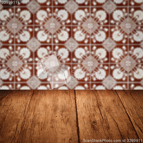 Image of Wood table top and blur vintage ceramic tile pattern wall