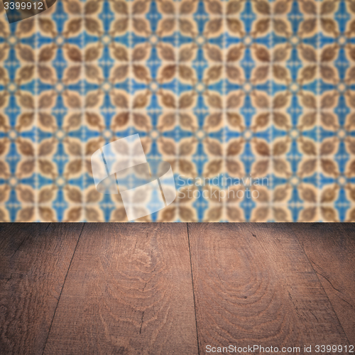 Image of Wood table top and blur vintage ceramic tile pattern wall