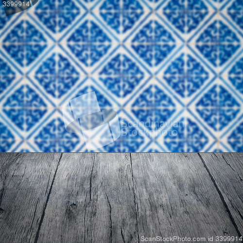 Image of Wood table top and blur vintage ceramic tile pattern wall