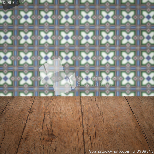 Image of Wood table top and blur vintage ceramic tile pattern wall