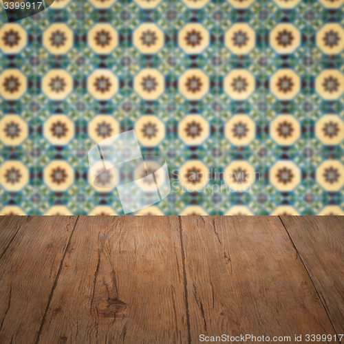 Image of Wood table top and blur vintage ceramic tile pattern wall