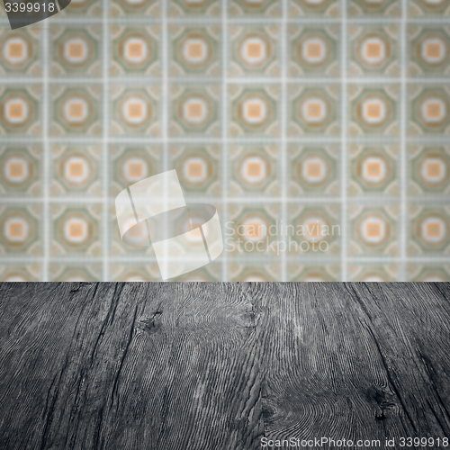 Image of Wood table top and blur vintage ceramic tile pattern wall