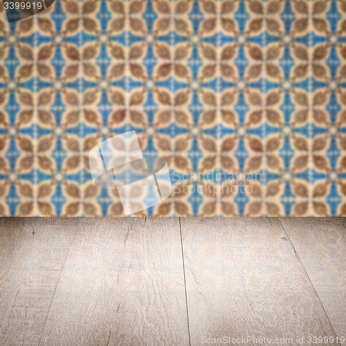 Image of Wood table top and blur vintage ceramic tile pattern wall