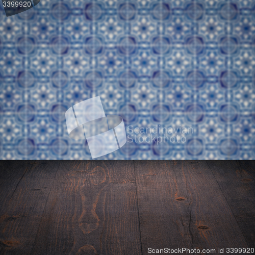 Image of Wood table top and blur vintage ceramic tile pattern wall