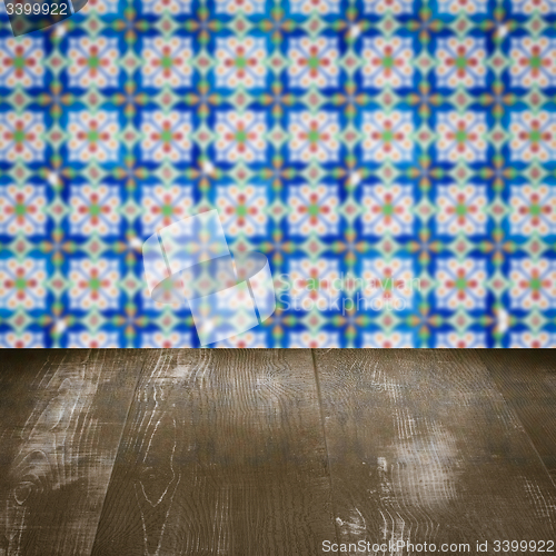 Image of Wood table top and blur vintage ceramic tile pattern wall