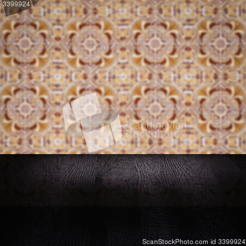 Image of Wood table top and blur vintage ceramic tile pattern wall