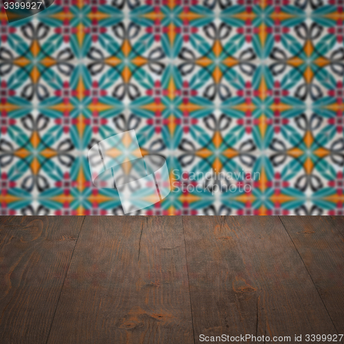 Image of Wood table top and blur vintage ceramic tile pattern wall