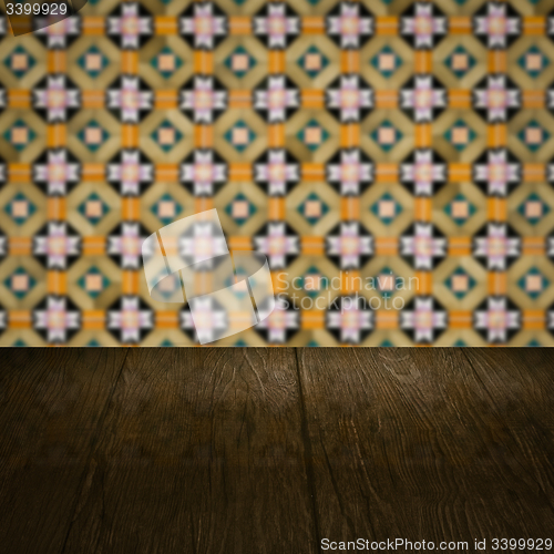 Image of Wood table top and blur vintage ceramic tile pattern wall