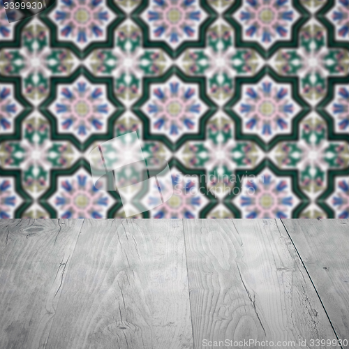 Image of Wood table top and blur vintage ceramic tile pattern wall