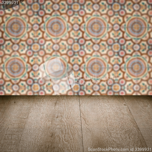 Image of Wood table top and blur vintage ceramic tile pattern wall