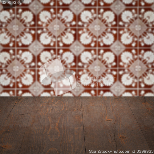 Image of Wood table top and blur vintage ceramic tile pattern wall