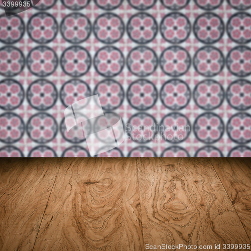 Image of Wood table top and blur vintage ceramic tile pattern wall