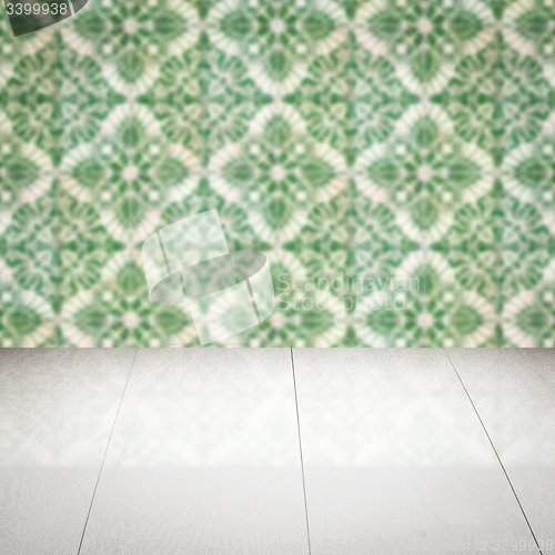 Image of Wood table top and blur vintage ceramic tile pattern wall