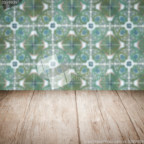 Image of Wood table top and blur vintage ceramic tile pattern wall