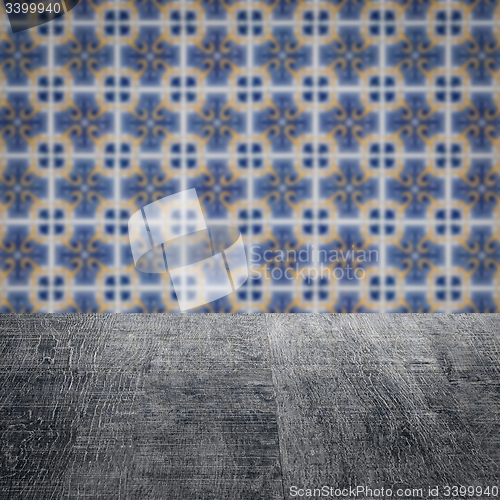 Image of Wood table top and blur vintage ceramic tile pattern wall