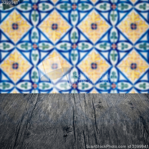 Image of Wood table top and blur vintage ceramic tile pattern wall