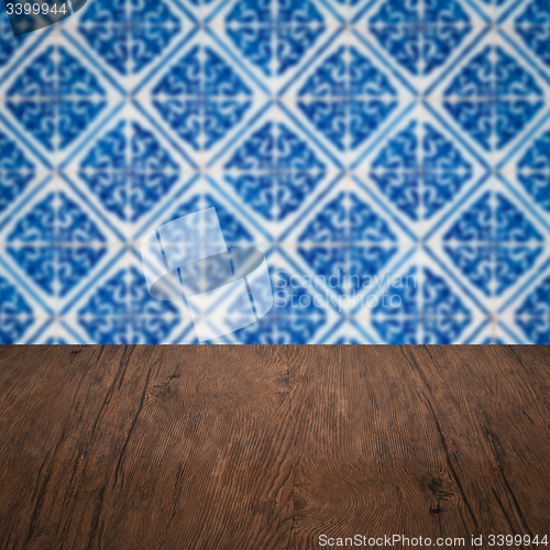 Image of Wood table top and blur vintage ceramic tile pattern wall