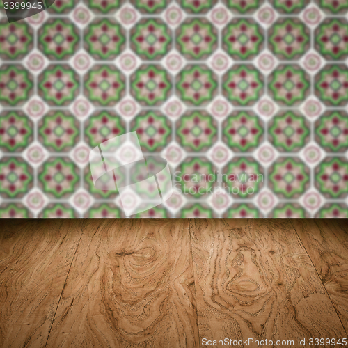 Image of Wood table top and blur vintage ceramic tile pattern wall