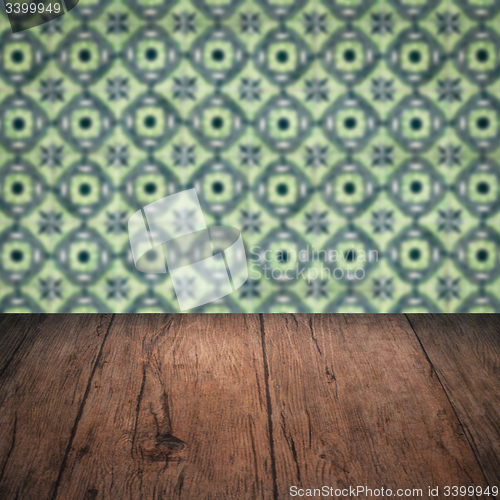 Image of Wood table top and blur vintage ceramic tile pattern wall