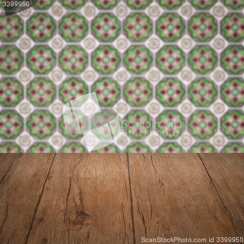 Image of Wood table top and blur vintage ceramic tile pattern wall