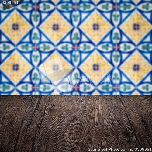 Image of Wood table top and blur vintage ceramic tile pattern wall