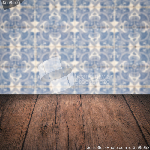Image of Wood table top and blur vintage ceramic tile pattern wall