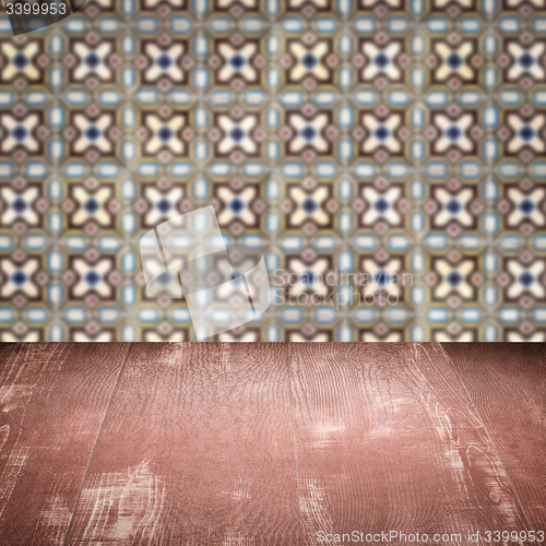 Image of Wood table top and blur vintage ceramic tile pattern wall