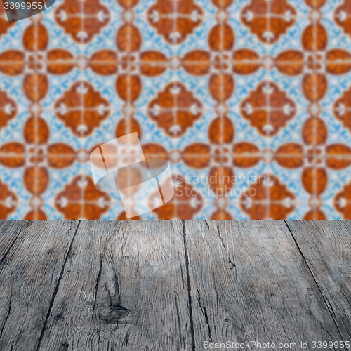 Image of Wood table top and blur vintage ceramic tile pattern wall