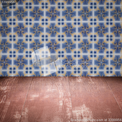 Image of Wood table top and blur vintage ceramic tile pattern wall