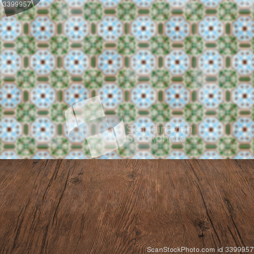 Image of Wood table top and blur vintage ceramic tile pattern wall