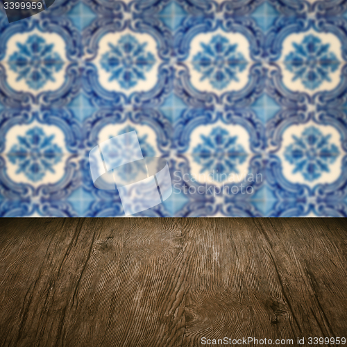 Image of Wood table top and blur vintage ceramic tile pattern wall