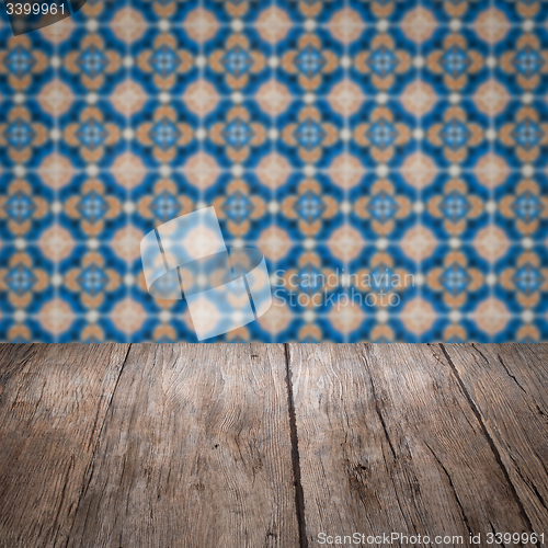 Image of Wood table top and blur vintage ceramic tile pattern wall