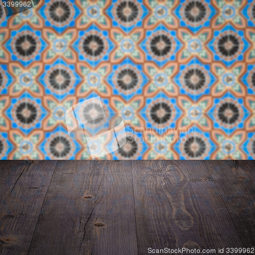 Image of Wood table top and blur vintage ceramic tile pattern wall