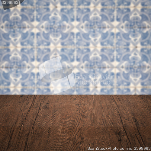 Image of Wood table top and blur vintage ceramic tile pattern wall